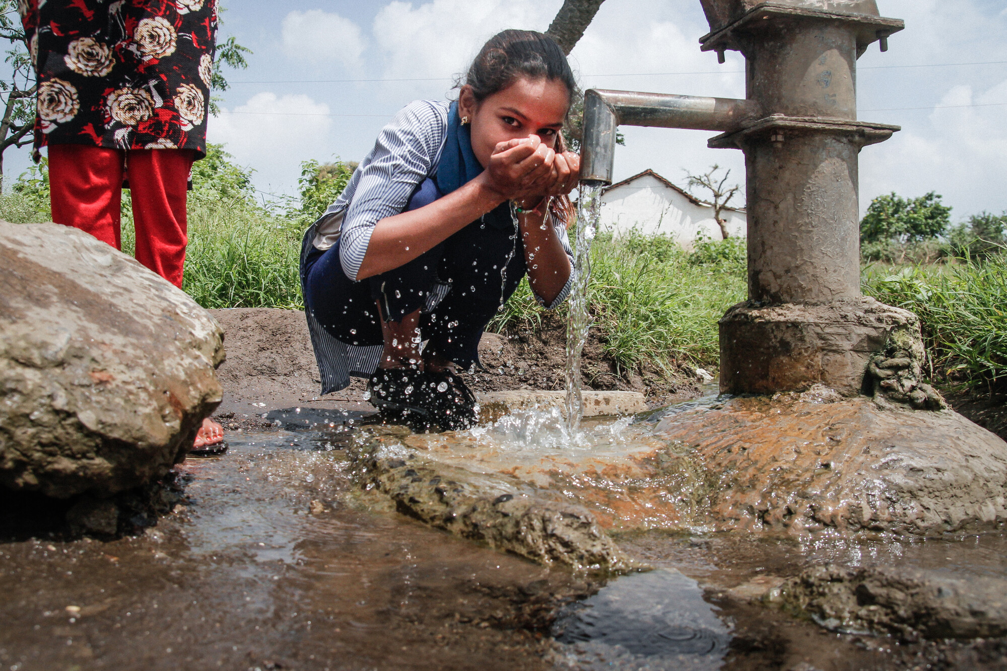 Sanju Mewada's friend drinking water from a handpump at Raipur Nayakheda, Madhya Pradesh, India, September 2018.