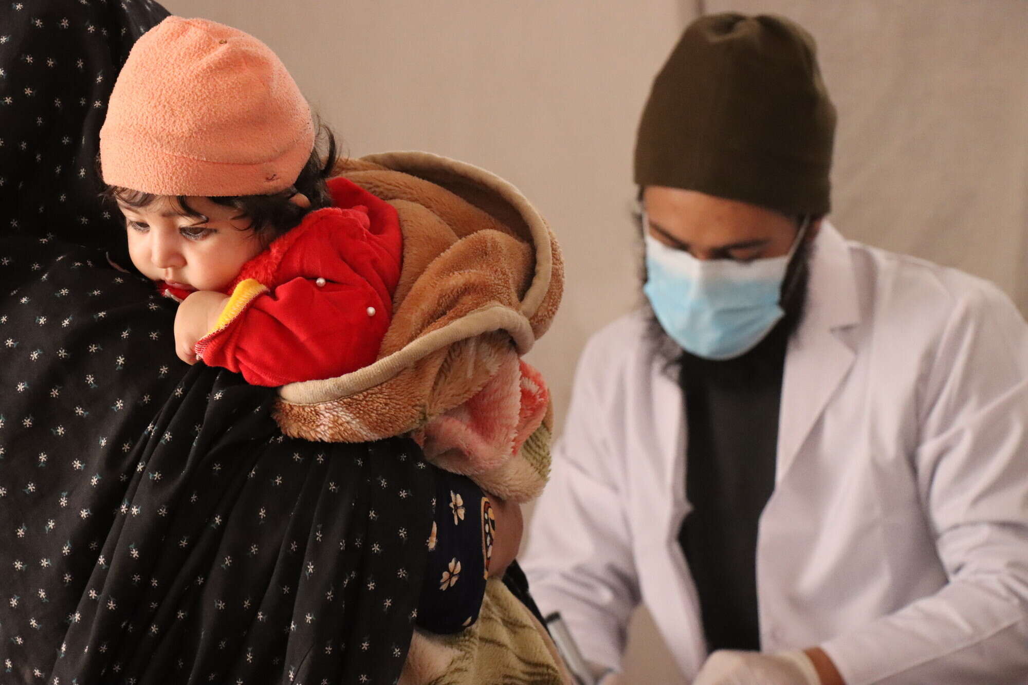 Belqees brought her six-month-old to this mobile health clinic in Nahr-e-abdullah. The clinic visits this village weekly, providing health services to more than 200 families each time.