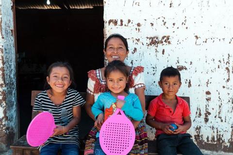 Alicia, 50, with her grandchildren at their home in Quiché.