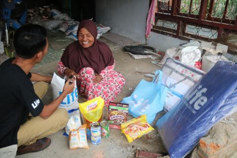 Distributing food packs and shelter kits in Indonesia.