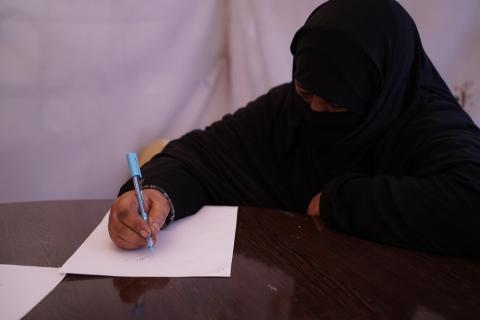 Woman participates in a literacy program in Syria.